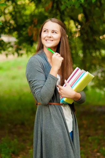 teen-girl-books-hands-near-tree-44843439